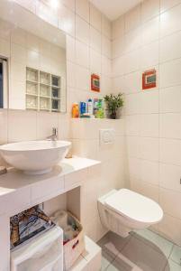 a white bathroom with a sink and a toilet at apartment with garden in Neuilly-sur-Seine