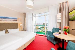 Postel nebo postele na pokoji v ubytování Garni Eden Hotels
