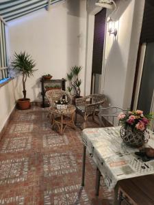 a living room with a table and chairs and plants at Home Sweet Home COSENZA in Cosenza