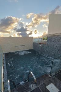 a swimming pool with a view of the ocean at Dar Khouadja maison d’hôtes in Mahdia