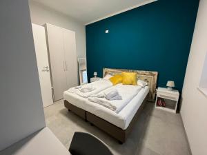 1 dormitorio con 1 cama con pared azul en La Corte in Fiera, en Verona