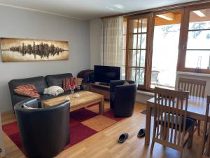 a living room with a couch and a table at Lovely 3 Bedroom Apartment, Ski in/Ski out in Obertauern