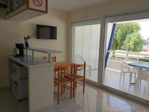 a kitchen and dining room with a table and chairs at Studio au Port Dienville in Dienville
