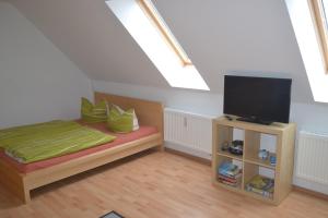 a bedroom with a bed and a flat screen tv at Haus Simone in Insel Poel