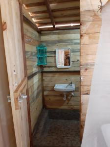 a bathroom with a sink in a wooden cabin at Blue Corner Beach Huts & Restaurant in Benaulim