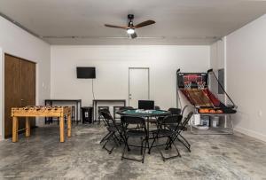 a room with a ping pong table and chairs and a ping pong table at Amazing downtown location for groups! in Little Rock