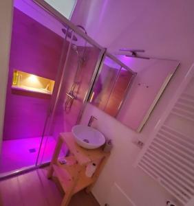 baño con lavabo e iluminación púrpura en SEA FRONT, Allegria, Santa Maria al Bagno, en Nardò