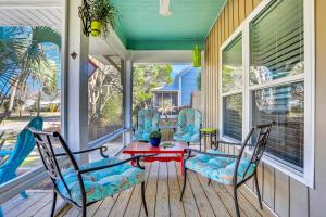 a porch with two chairs and a table on a house at Breaking Winds in Port Saint Joe