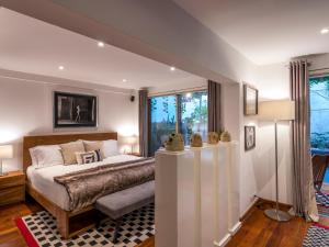 a bedroom with a bed and a large window at Grand Cinema & Jacuzzi Appartment in Mexico City