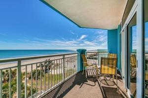 a balcony with chairs and a view of the ocean at Ocean Blue - Ocean View Condos by Coastline Resorts in Myrtle Beach