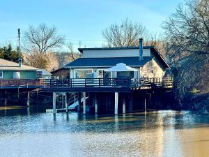 a house on a dock on a body of water at Fishing bungalow on the water w/private dock in Clearlake