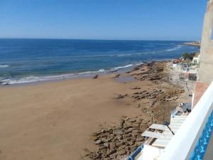 a view of a beach with rocks and the ocean at Taghazout Waves 1 in Taghazout