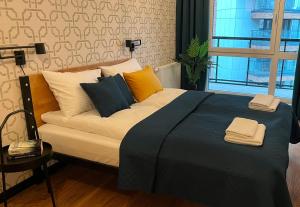 a bedroom with a large bed with pillows on it at PM. Apartments Krakow in Kraków