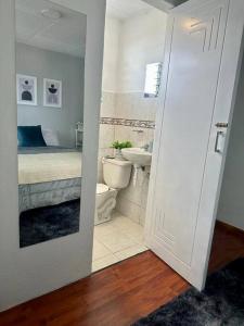 a bathroom with a bed and a toilet and a sink at Nonno’s House in Cuenca