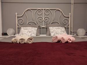 a bed with a metal headboard and pillows on it at FILUTE in Vrbovsko