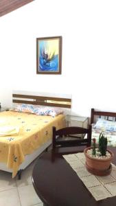 a bedroom with two beds and a glass table at Pousada Montanha da Pedra Grande in Atibaia
