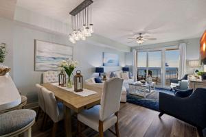 a dining room and living room with a dining table at Beach N View Calypso 3 in Panama City Beach