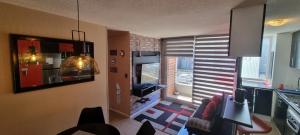 a living room with a view of a kitchen with a window at Hermoso departamento in Puerto Montt