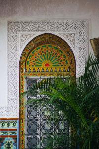 uma porta ornamentada com um padrão colorido numa parede em Riad Amelia : Lalla Nora Room em Tetouan