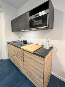 a kitchen with a sink and a microwave at VELASQUEZ APARTMENTS - A - San Siro in Milan