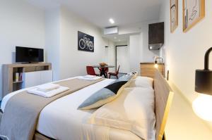 a bedroom with a large bed with white sheets and pillows at VELASQUEZ APARTMENTS - A - San Siro in Milan