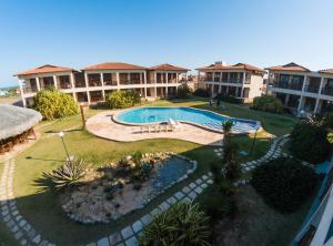 an aerial view of a resort with a swimming pool at TAIBA - ONDAS DO MAR RESIDENCE Ap 212 - Rezende Temporada in São Gonçalo do Amarante