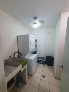 a small bathroom with a sink and a microwave at Central Departamento in Mazatlán