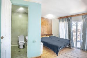 a small bedroom with a bed and a toilet at sweet dreams bakuriani in Bakuriani