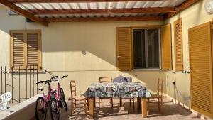 a patio with a table and chairs and bikes at Mezzaluna Guest House in Baronissi