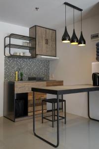 a kitchen with a table and some lights at Student park apartment in Seturan