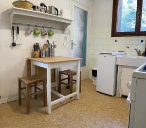 a kitchen with a table and stools in a room at Appartement Cassis Plage in Cassis