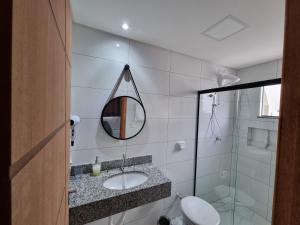 a bathroom with a sink and a mirror at Águas de Canto Grande in Bombinhas +91 photos