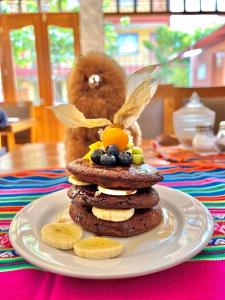 a stack of cookies on a plate on a table at Pisac Inca Guest House in Pisac