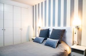 um quarto com uma cama com almofadas azuis em Rota Mar em Rota