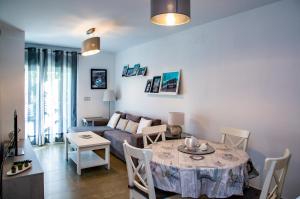 a living room with a table and a couch at Rota Mar in Rota