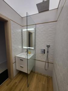 a bathroom with a sink and a glass shower at AMAYA in Varna City +112 photos