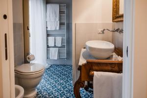 a bathroom with a toilet and a sink at Locanda Mescoglia in Corciano +33 photos