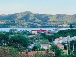 a view of a town with a lake and mountains at Casa Familiar (con Vista al Lago) in Potrero de los Funes