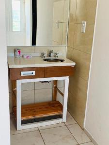 a bathroom with a sink and a mirror at Casa Familiar (con Vista al Lago) in Potrero de los Funes