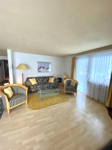 a living room with a couch and two chairs at Chalet Alm in Zermatt