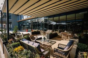 a patio with chairs and tables and a building at Gori Inn in Gori