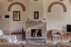 a living room with a couch and a fireplace at Podere Ferranino at Ville Ferrano in San Giovanni dʼAsso