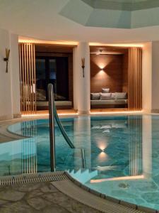 a swimming pool in the middle of a house at Lech Valley Lodge in Warth am Arlberg