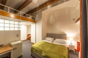 a bedroom with a large bed and a desk at S42 Hotel Prague in Prague