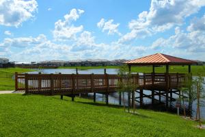 a wooden bridge over a river with a gazebo at Five Bedrooms TownHome with Pool 4849 in Kissimmee