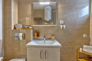 a bathroom with a sink and a mirror at Dobro Mesto in Zlatibor +11 photos