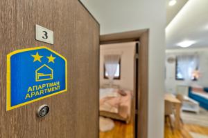 a blue and yellow sign on a door in a room at Dobro Mesto in Zlatibor
