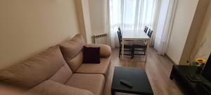 a living room with a couch and a table at CIRCUNVALACION in Albacete