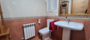 a bathroom with a white sink and a toilet at CIRCUNVALACION in Albacete