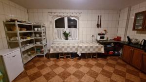 a kitchen with a table in the middle of a room at Willa u Skrajnioka in Czerwienne